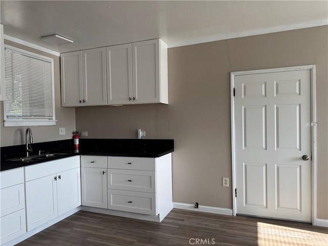 7531 Del Rosa Ave, San Bernardino, CA 92410 - kitchen featuring a sink, dark wood-type flooring, dark countertops, and baseboards