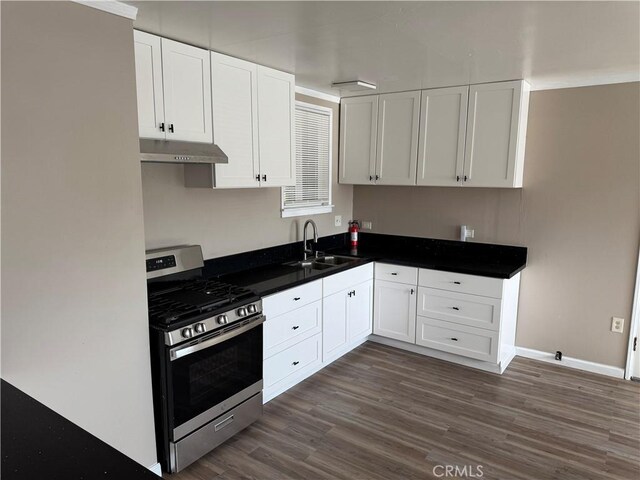 7531 Del Rosa Ave, San Bernardino, CA 92410 - kitchen with stainless steel gas range oven, a sink, under cabinet range hood, and white cabinetry