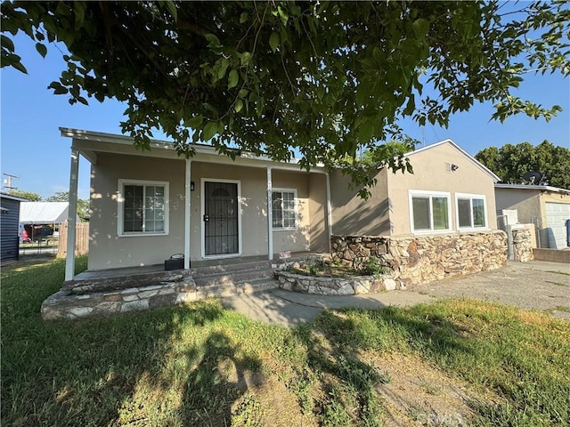 7531 Del Rosa Ave, San Bernardino, CA 92410 - view of front of house with stucco siding, a porch, and stone siding