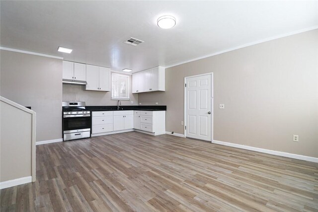 7531 Del Rosa Ave, San Bernardino, CA 92410 - kitchen featuring stainless steel gas range, a sink, light wood-style flooring, white cabinets, and baseboards
