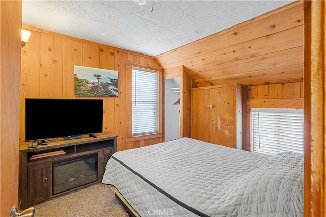 233 Glen Avon Dr, Cedar Glen, CA 92321 - carpeted bedroom featuring lofted ceiling, wooden walls, and a textured ceiling