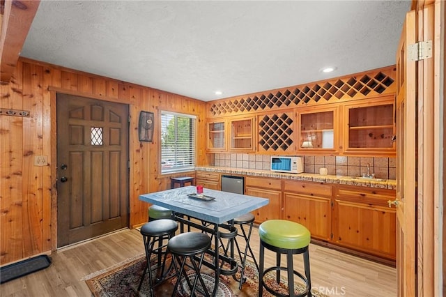 233 Glen Avon Dr, Cedar Glen, CA 92321 - dining area featuring light wood-type flooring, recessed lighting, a textured ceiling, and wooden walls