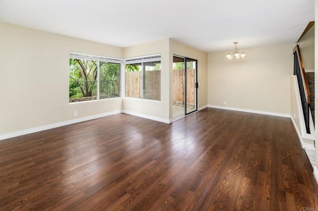 1253 Manzana Way, San Diego, CA 92139 - spare room featuring a chandelier, dark wood-style flooring, and baseboards
