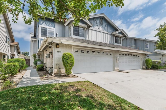 1253 Manzana Way, San Diego, CA 92139 - townhome / multi-family property with concrete driveway, stucco siding, an attached garage, and board and batten siding