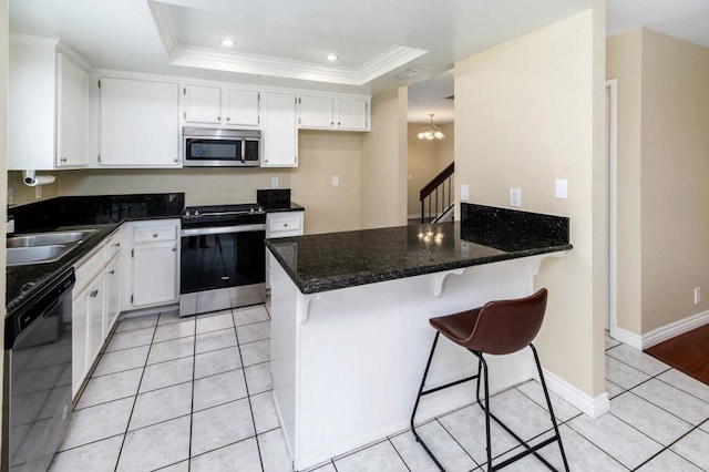 1253 Manzana Way, San Diego, CA 92139 - kitchen featuring stainless steel appliances, a peninsula, a sink, dark stone counters, and ornamental molding