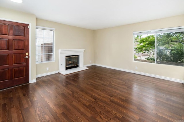 1253 Manzana Way, San Diego, CA 92139 - unfurnished living room with healthy amount of natural light, dark wood-style flooring, and baseboards