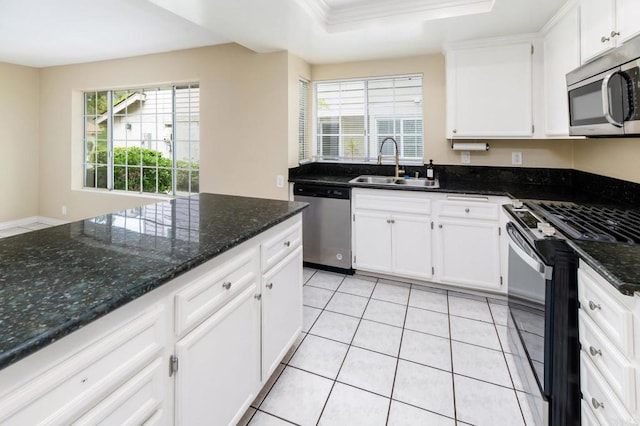 1253 Manzana Way, San Diego, CA 92139 - kitchen with stainless steel appliances, a sink, healthy amount of natural light, white cabinets, and ornamental molding