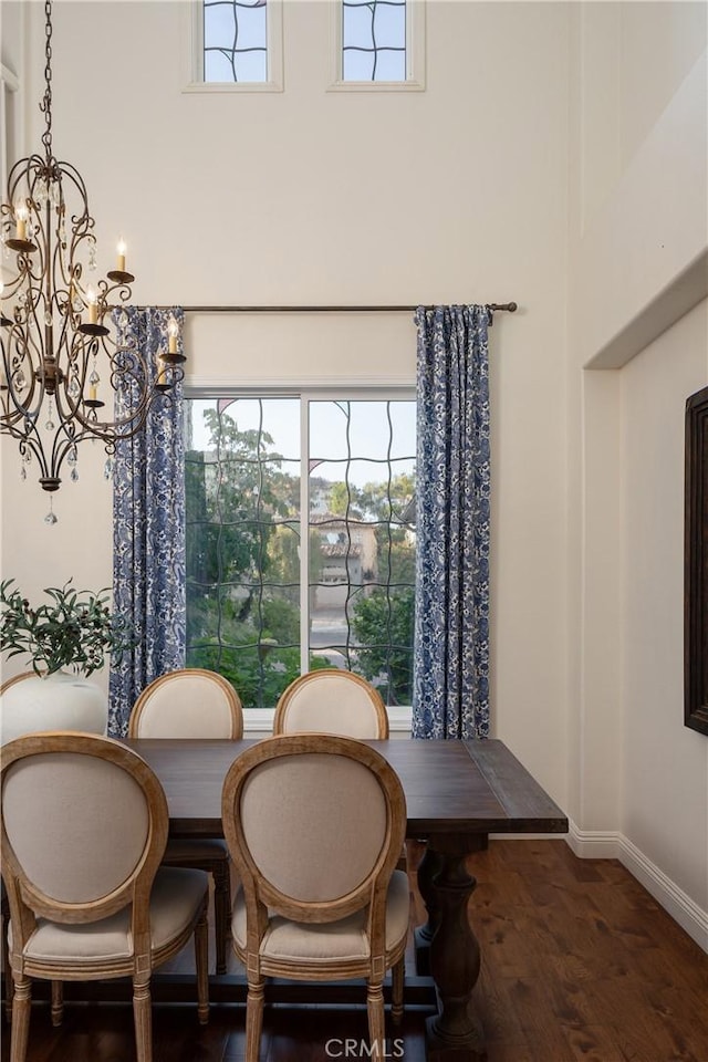 114 Via Monte Picayo, San Clemente, CA 92673 - dining space featuring a chandelier, dark wood finished floors, a high ceiling, and baseboards