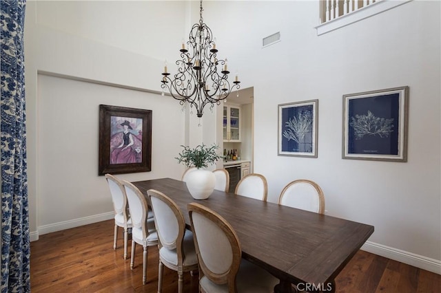 114 Via Monte Picayo, San Clemente, CA 92673 - dining area featuring a chandelier, baseboards, wood finished floors, and a towering ceiling