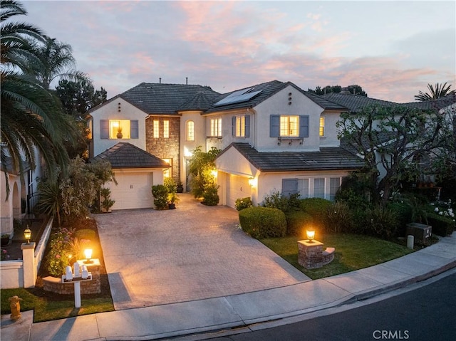 114 Via Monte Picayo, San Clemente, CA 92673 - traditional home featuring stucco siding, decorative driveway, solar panels, a garage, and stone siding