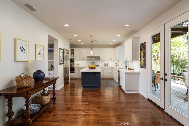 114 Via Monte Picayo, San Clemente, CA 92673 - kitchen with a sink, stainless steel appliances, a kitchen island, white cabinetry, and light countertops