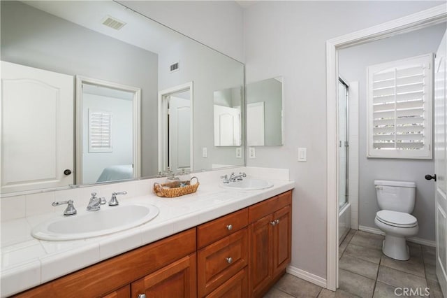 114 Via Monte Picayo, San Clemente, CA 92673 - bathroom with double vanity, toilet, tile patterned flooring, enclosed tub / shower combo, and baseboards