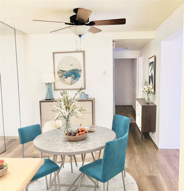 897 Ronda Sevilla C, Laguna Woods, CA 92637 - dining room with a ceiling fan and light wood-style floors