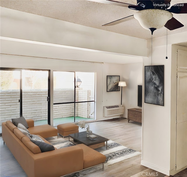 897 Ronda Sevilla C, Laguna Woods, CA 92637 - living room with light wood finished floors, a ceiling fan, and a wall mounted air conditioner