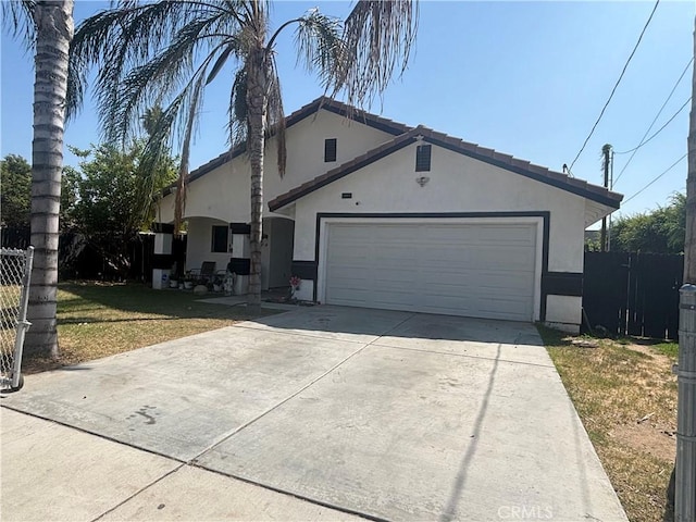 3360 Winstrom St, Riverside, CA 92504 - view of front of house with stucco siding, driveway, and a garage