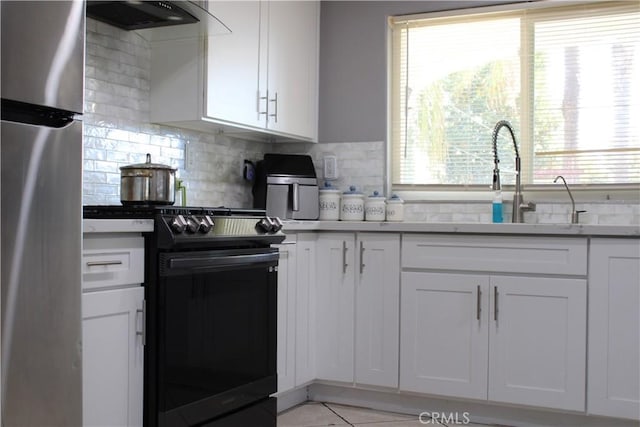 3360 Winstrom St, Riverside, CA 92504 - kitchen with freestanding refrigerator, black gas range oven, range hood, and decorative backsplash