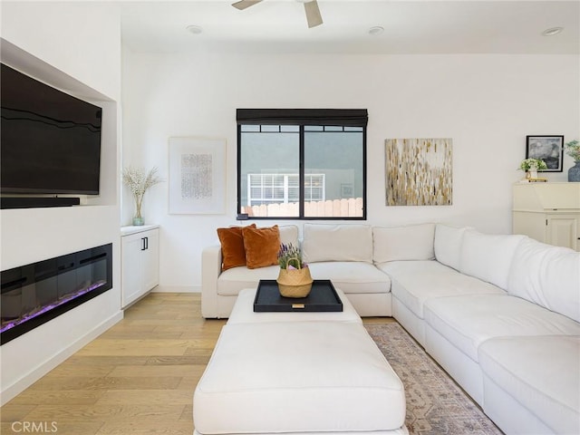 618 W Elm Ave, El Segundo, CA 90245 - living area featuring light wood-style floors, a ceiling fan, and a glass covered fireplace