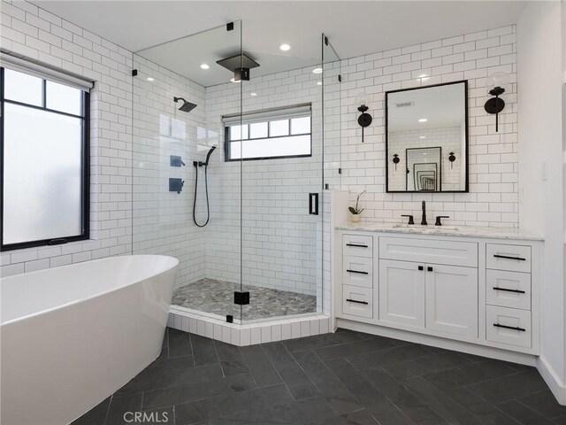618 W Elm Ave, El Segundo, CA 90245 - bathroom featuring tile walls, a stall shower, a soaking tub, vanity, and healthy amount of natural light