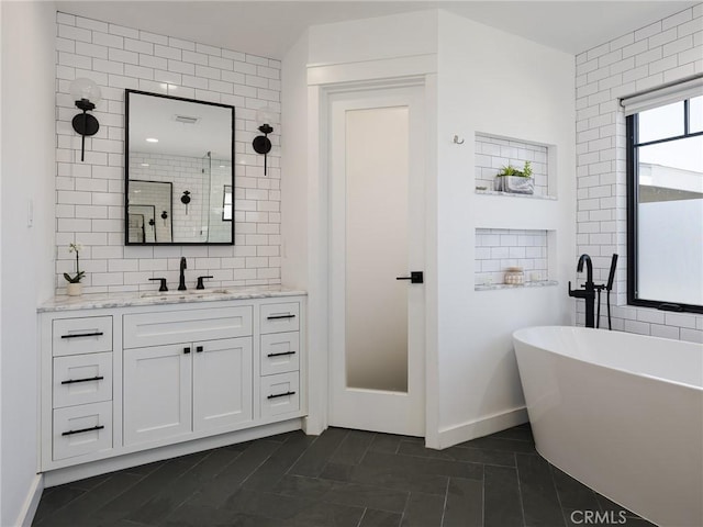 618 W Elm Ave, El Segundo, CA 90245 - full bathroom with a freestanding tub, tile walls, vanity, tiled shower, and tile patterned flooring