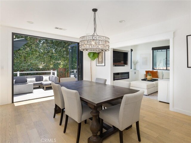 618 W Elm Ave, El Segundo, CA 90245 - dining room featuring light wood-style flooring and a glass covered fireplace