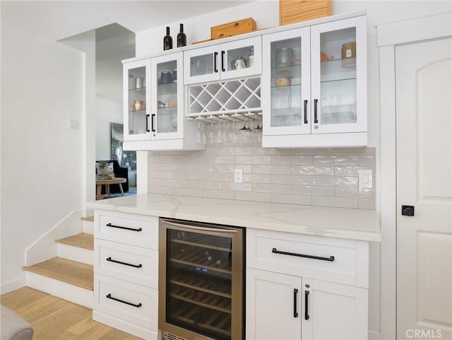 618 W Elm Ave, El Segundo, CA 90245 - indoor dry bar with beverage cooler, decorative backsplash, light wood-style floors, stairway, and baseboards