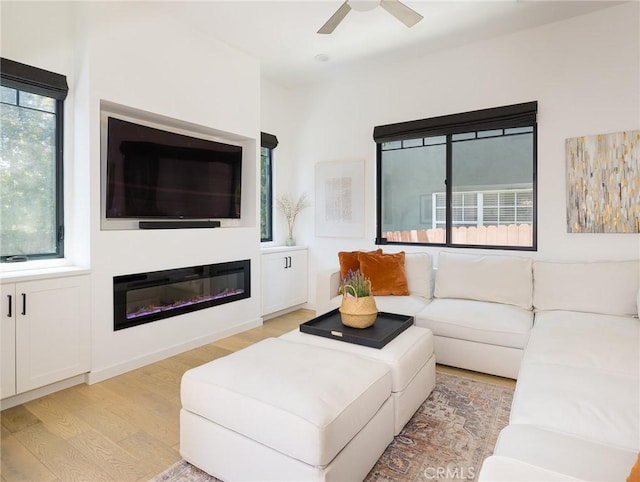 618 W Elm Ave, El Segundo, CA 90245 - living room with light wood-style flooring, a ceiling fan, and a glass covered fireplace