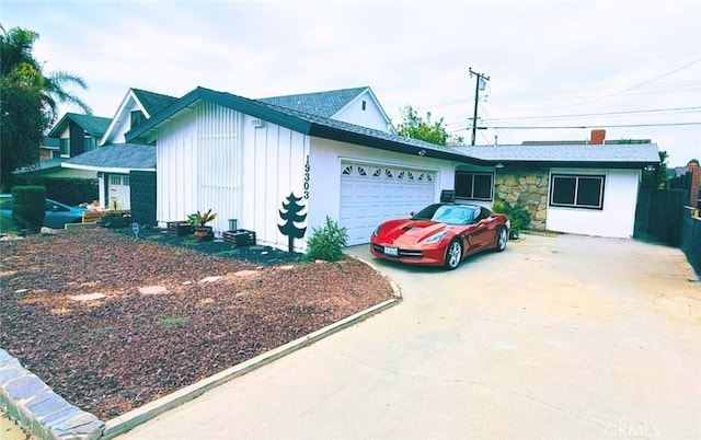 19303 Kemp Ave, Carson, CA 90746 - view of side of property with board and batten siding, a garage, and concrete driveway