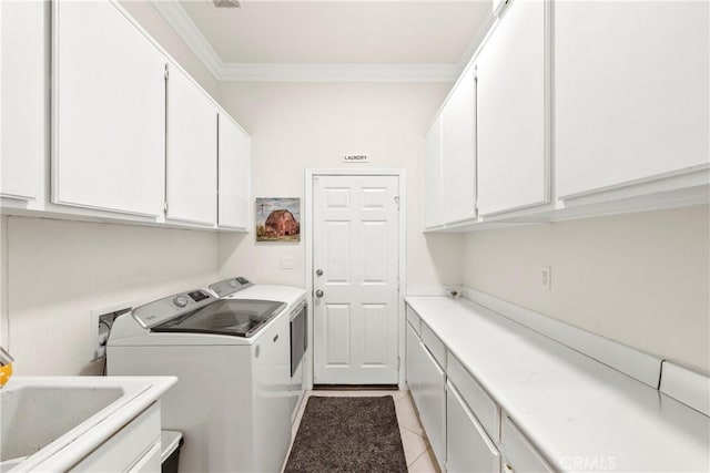 42302 Oregon Trl, Murrieta, CA 92562 - laundry room with cabinet space, ornamental molding, washer and dryer, and light tile patterned floors
