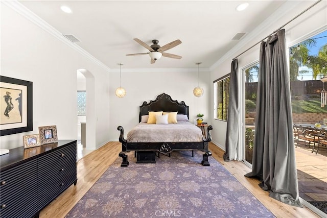 42302 Oregon Trl, Murrieta, CA 92562 - bedroom featuring multiple windows, access to exterior, wood finished floors, crown molding, and arched walkways