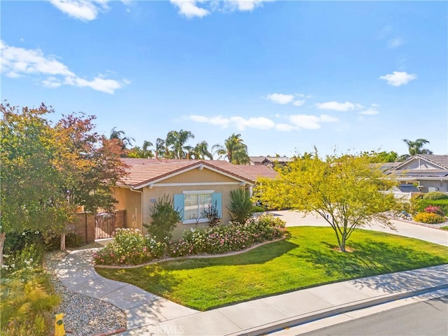 42302 Oregon Trl, Murrieta, CA 92562 - view of front of property with a front lawn, a tiled roof, a gate, and stucco siding