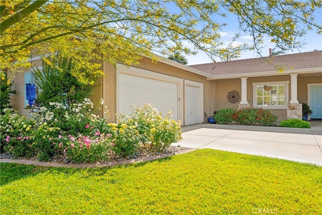 42302 Oregon Trl, Murrieta, CA 92562 - view of front of house with stucco siding, an attached garage, driveway, and a front yard