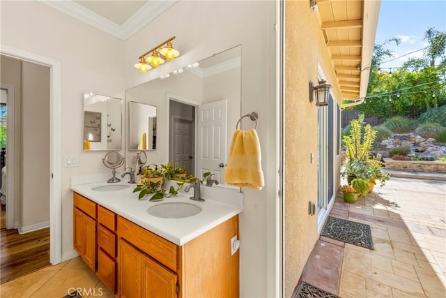42302 Oregon Trl, Murrieta, CA 92562 - full bathroom featuring double vanity, ornamental molding, plenty of natural light, and baseboards