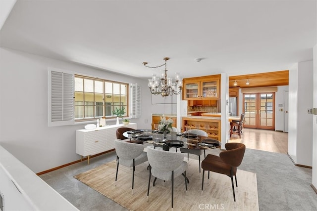 1110 Esplanade Unit 6, Redondo Beach, CA 90277 - dining area with a chandelier, baseboards, light carpet, and french doors