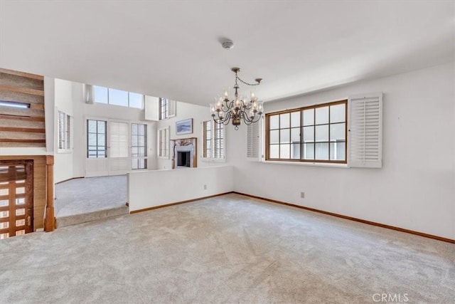 1110 Esplanade Unit 6, Redondo Beach, CA 90277 - unfurnished living room featuring a fireplace, a chandelier, carpet floors, and baseboards