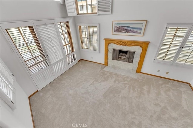 1110 Esplanade Unit 6, Redondo Beach, CA 90277 - unfurnished living room featuring carpet flooring, a fireplace, baseboards, and plenty of natural light