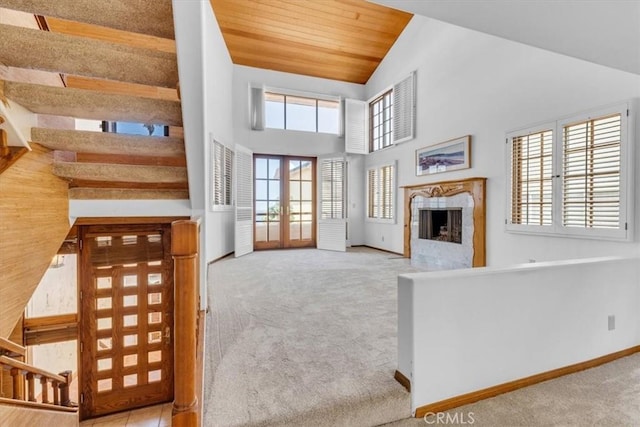 1110 Esplanade Unit 6, Redondo Beach, CA 90277 - unfurnished living room featuring carpet, stairway, a fireplace, french doors, and baseboards