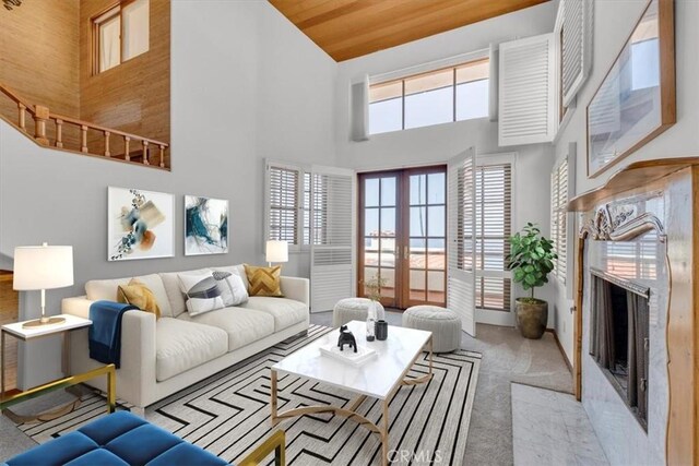 1110 Esplanade Unit 6, Redondo Beach, CA 90277 - carpeted living room featuring high vaulted ceiling, french doors, a fireplace, and wooden ceiling