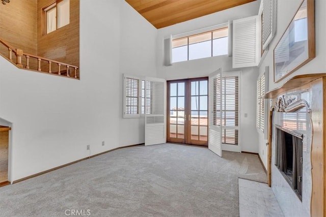 1110 Esplanade Unit 6, Redondo Beach, CA 90277 - unfurnished living room featuring carpet flooring, french doors, high vaulted ceiling, a fireplace, and baseboards
