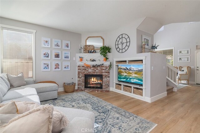 43340 Corte Barbaste, Temecula, CA 92592 - living room with wood finished floors, a fireplace, baseboards, stairs, and vaulted ceiling