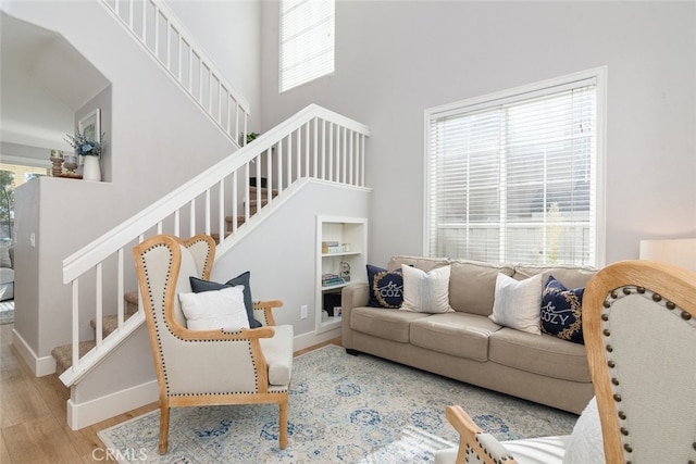 43340 Corte Barbaste, Temecula, CA 92592 - living room featuring stairway, wood finished floors, plenty of natural light, a towering ceiling, and baseboards
