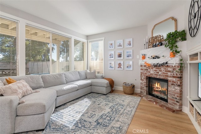 43340 Corte Barbaste, Temecula, CA 92592 - living room with light wood-style flooring, a brick fireplace, and baseboards