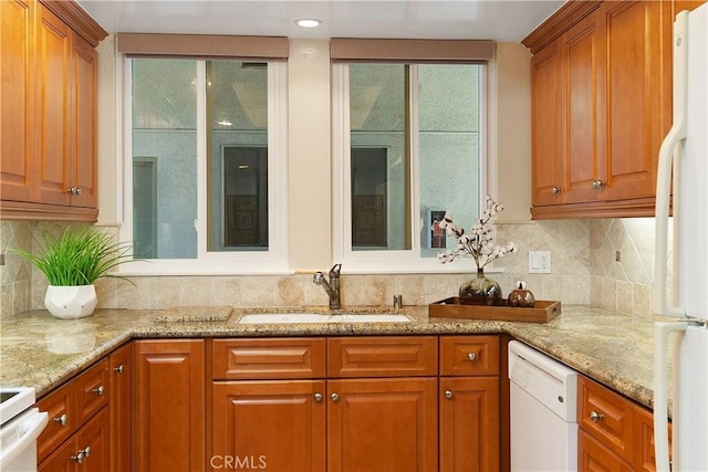 124 Via Estrada Unit O, Laguna Woods, CA 92637 - kitchen featuring a sink, white appliances, brown cabinetry, light stone counters, and tasteful backsplash