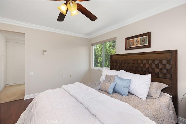 124 Via Estrada Unit O, Laguna Woods, CA 92637 - bedroom with wood finished floors, ornamental molding, baseboards, and a ceiling fan