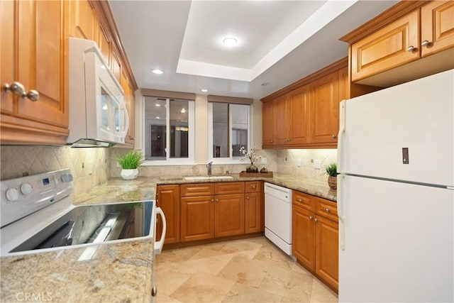 124 Via Estrada Unit O, Laguna Woods, CA 92637 - kitchen featuring white appliances, a sink, light stone countertops, tasteful backsplash, and brown cabinets
