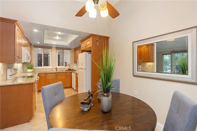 124 Via Estrada Unit O, Laguna Woods, CA 92637 - dining area with a ceiling fan and a tray ceiling
