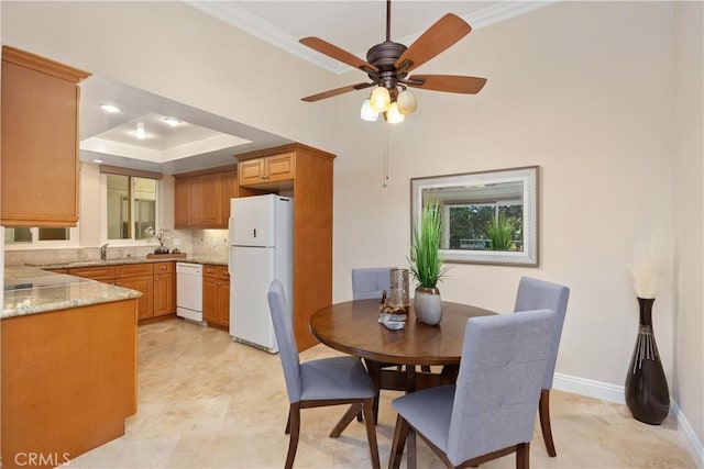 124 Via Estrada Unit O, Laguna Woods, CA 92637 - dining space with a tray ceiling, ceiling fan, baseboards, and ornamental molding