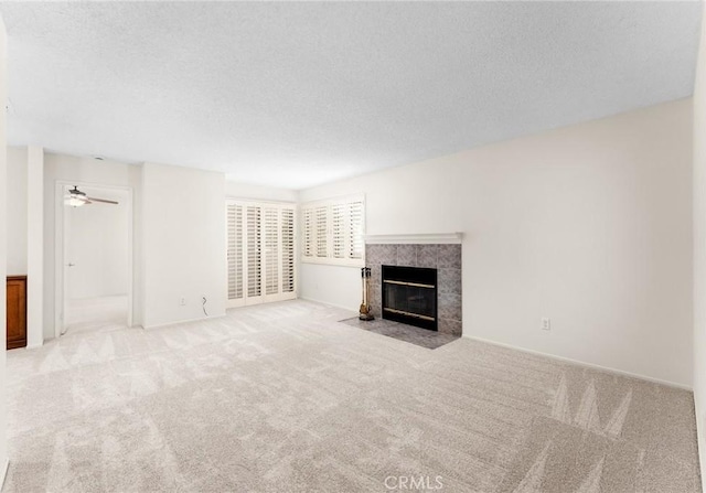 8313 Vineyard Ave # 6, Rancho Cucamonga, CA 91730 - unfurnished living room featuring a tile fireplace, carpet floors, and a textured ceiling