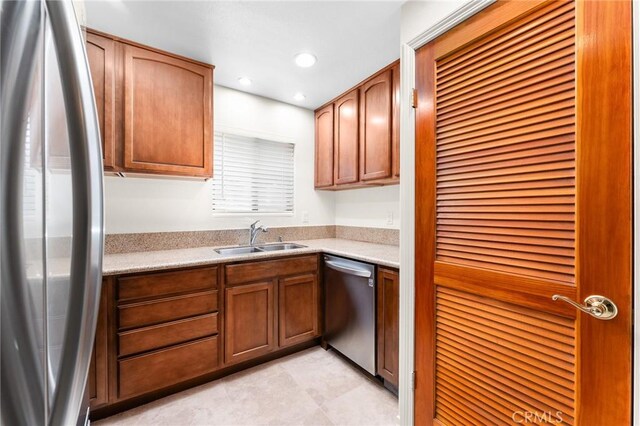 8313 Vineyard Ave # 6, Rancho Cucamonga, CA 91730 - kitchen with a sink, stainless steel appliances, light countertops, recessed lighting, and brown cabinetry