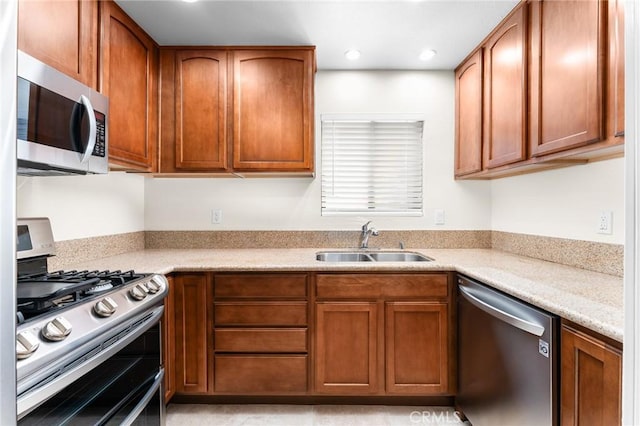 8313 Vineyard Ave # 6, Rancho Cucamonga, CA 91730 - kitchen with stainless steel appliances, a sink, light countertops, brown cabinetry, and recessed lighting