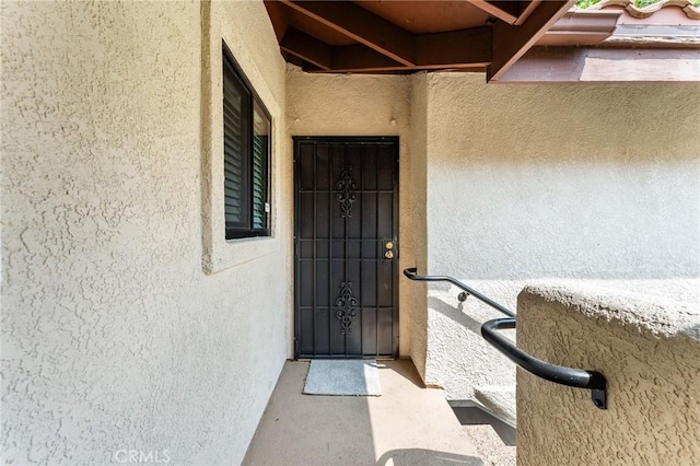 8313 Vineyard Ave # 6, Rancho Cucamonga, CA 91730 - doorway to property with stucco siding